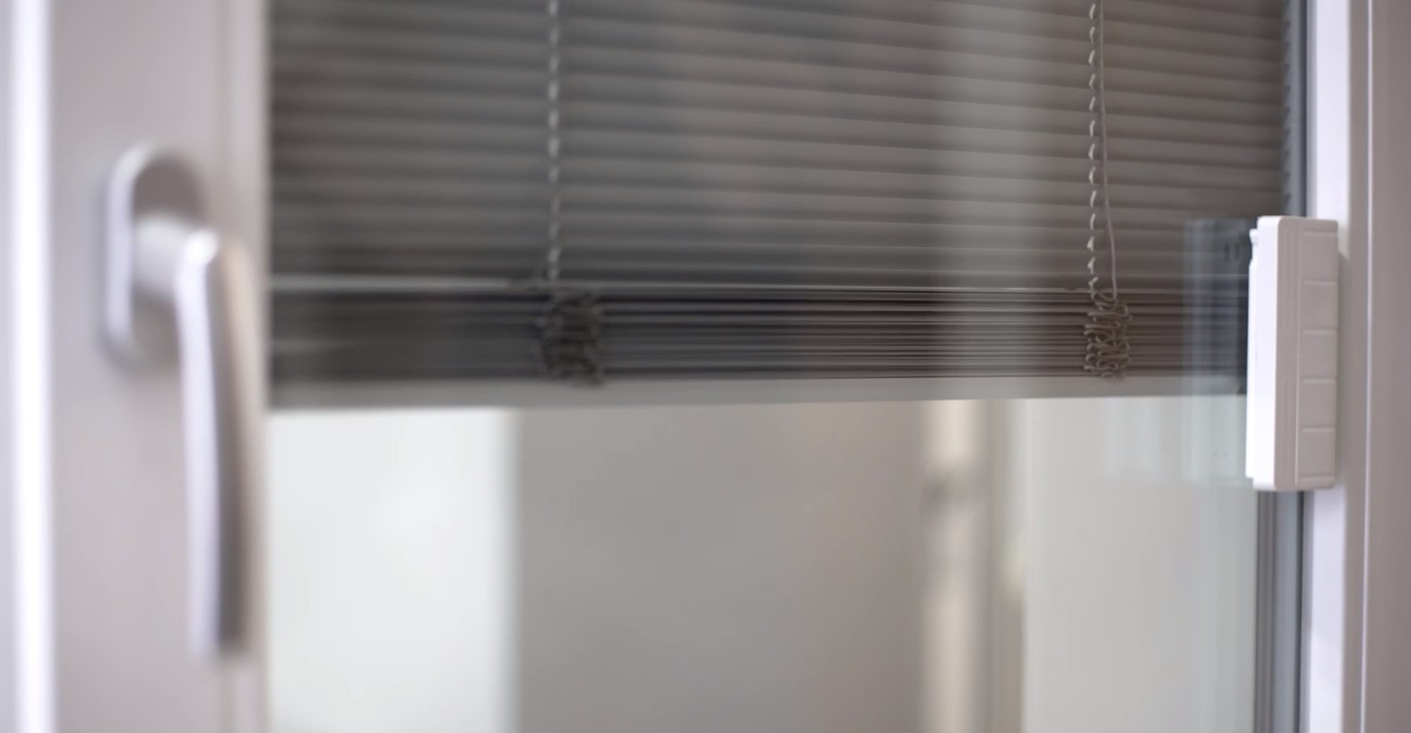 motorization bringing shades down on a window